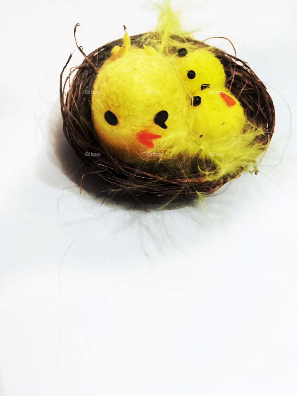 Little toy chicks and chicken in nest