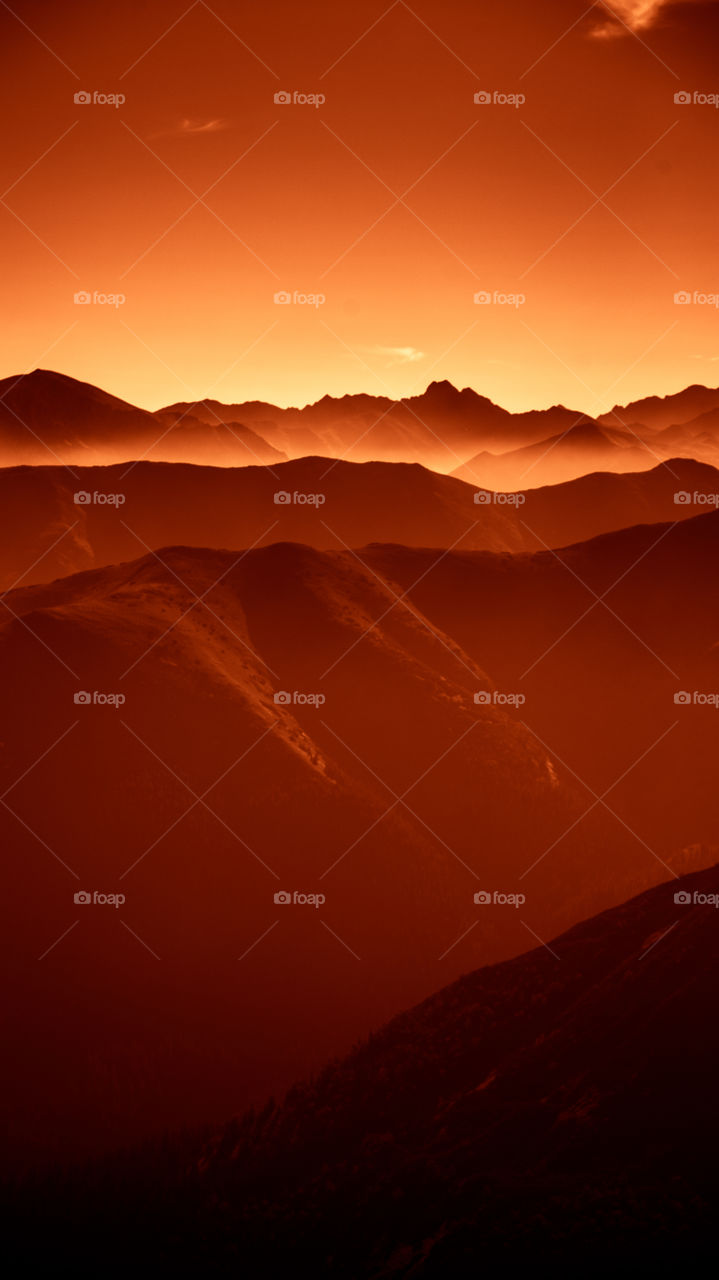 An inspiring red mountain landscape. Tatry mountains in Slovakia. A beautiful wallpaper for smartphone screen. Red abstract gradient with perspective.