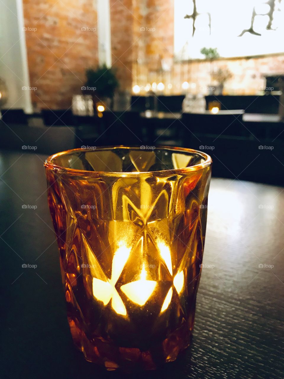 A candle In a class on a table