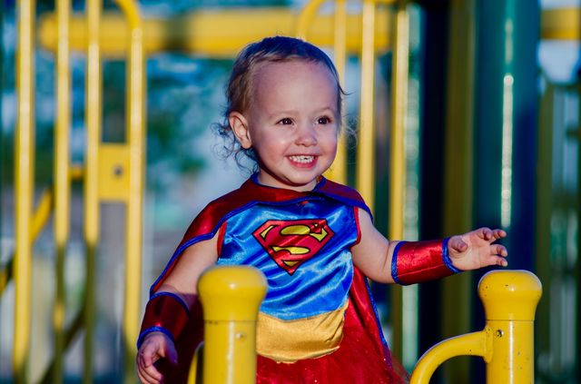 Portrait of baby girl wearing superhero costume
