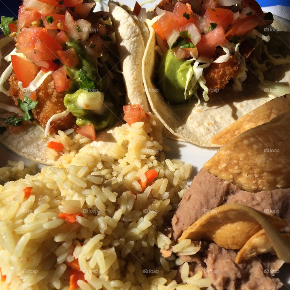 Tacos, rice, and refried beans