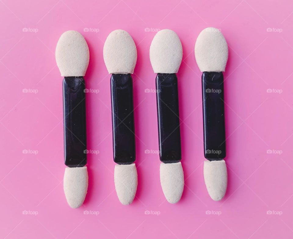 eyeshadow stick brushes in pink background