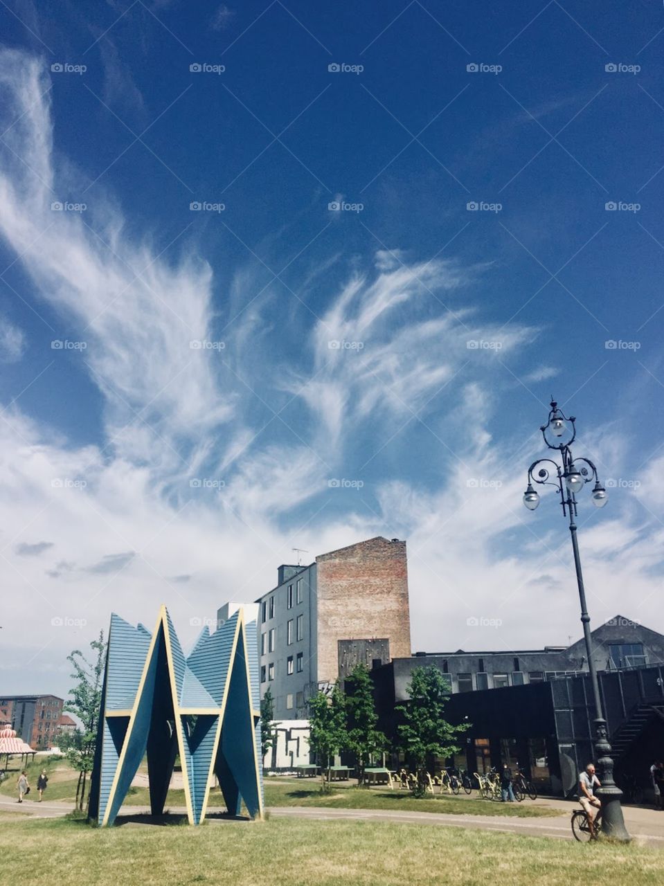 Art installation in an urban park under the clear blue sky filled with wispy clouds
