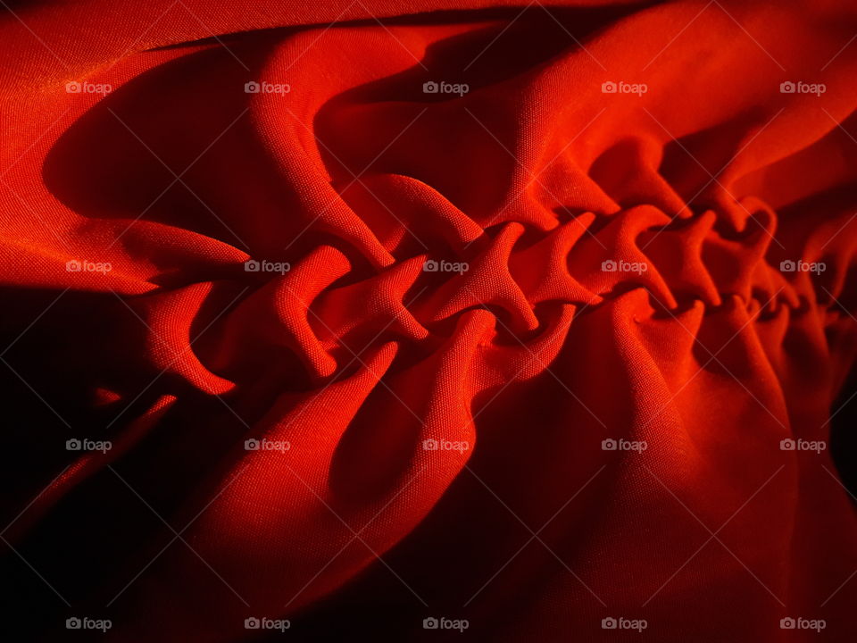 simple red cloth material stitched by hand to form dEsigner  pattern