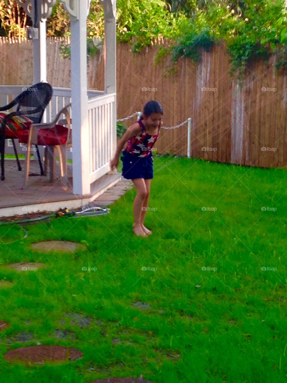 Backyard fun under the sprinkler