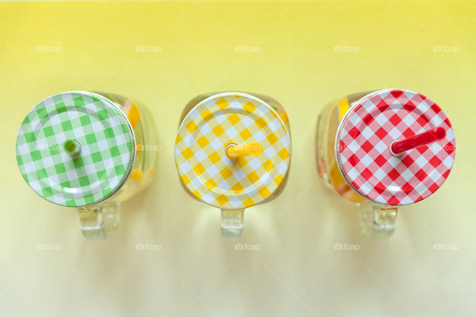 Homemade citrus lemonade in three glass jars, view from the top