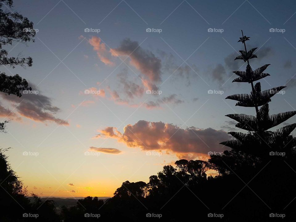 As night time falls the sun casts its last Ray's of beauty against the sky making the clouds a beautiful colorful scene. Lovely.