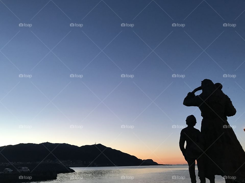 Statues watching the sunset.