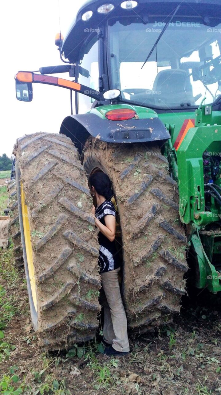 Stuck between a rock and a hard place between two tractor tires 
