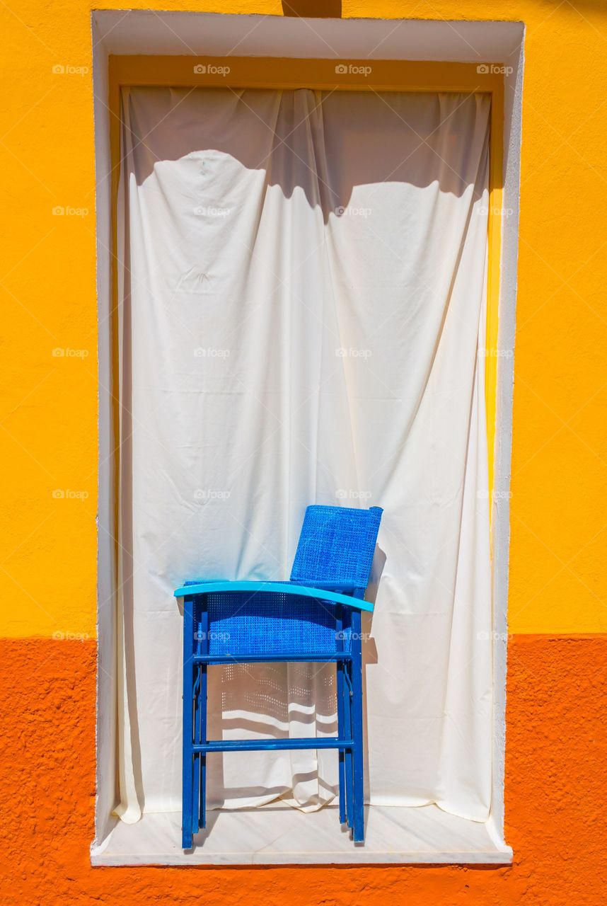 Window with blue chair 