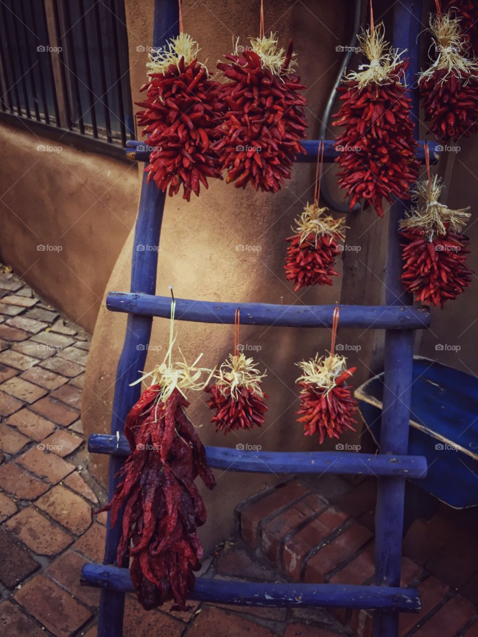 Red chili peppers on blue ladder