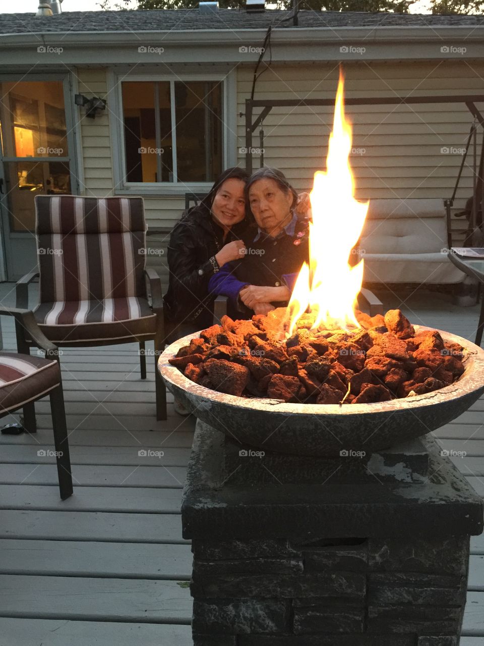 Mother and daughter enjoying a great evening by the fire. Mother and daughter enjoying a great evening by the fire