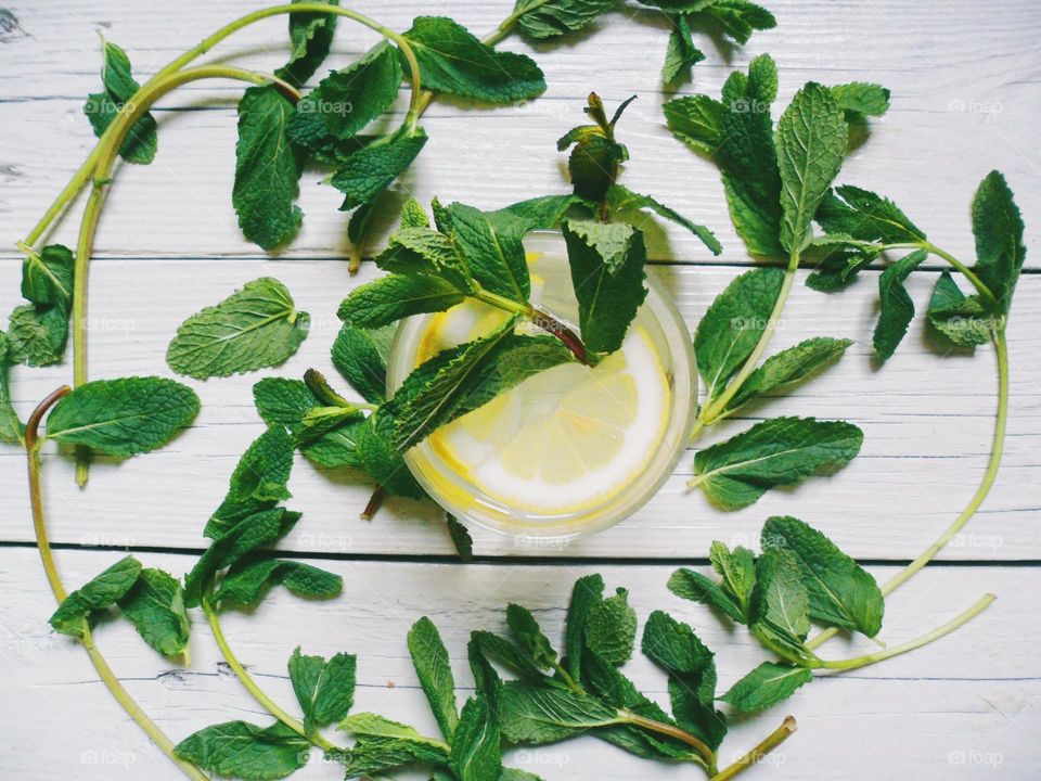 Homemade lemonade with lemon and mint leaves