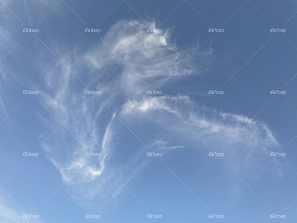 Clouds that look like an angel blowing pixie dust off hand