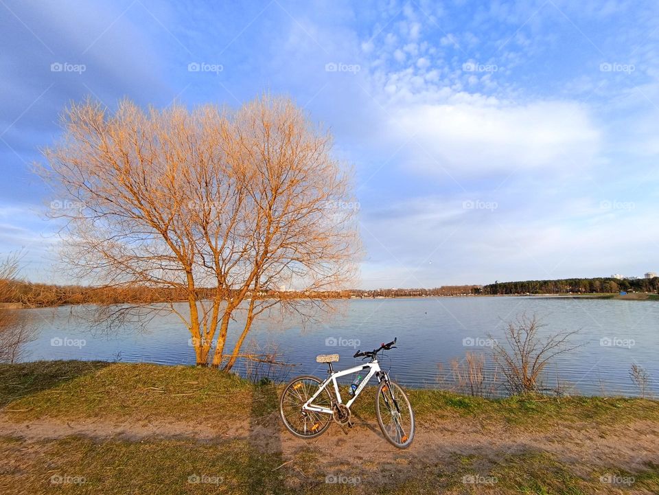 one bike on a lake shore beautiful nature landscape blue sky background