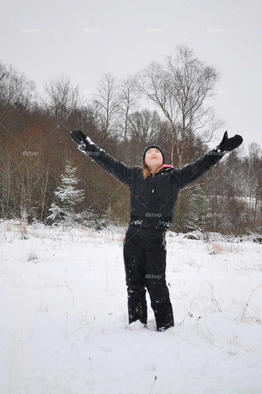 Girl with the hands in the air a winter day