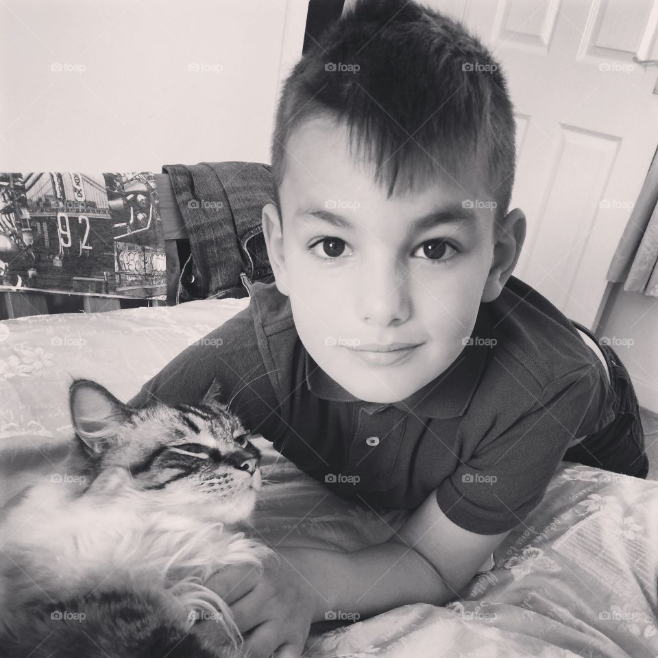 boy and his pet cat cuddling.