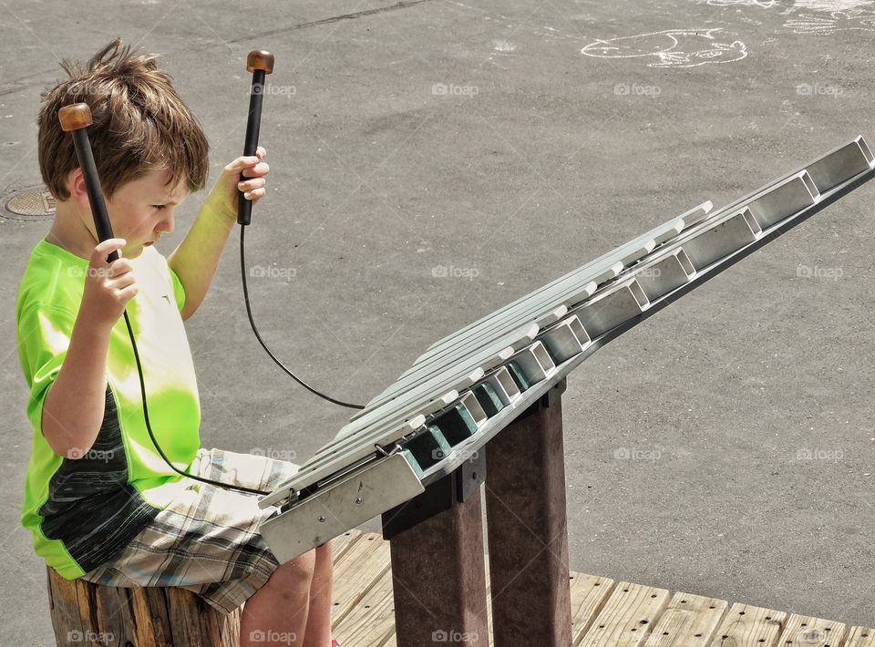 Young Street Musician. Boy Playing Giant Xylophone
