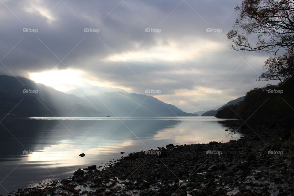 Sun beams coming through the clouds over a beautiful Loch Lomond