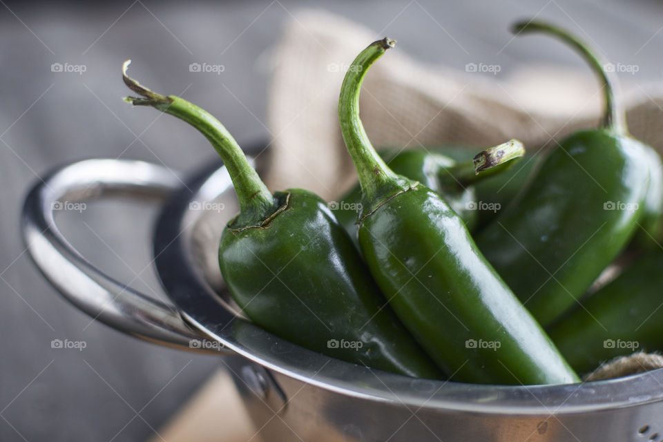 Close-up of a Bowl of green chilli peppers