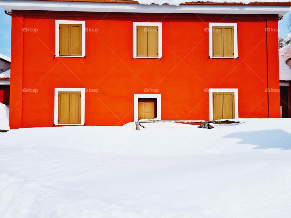 orange colored house covered with snow