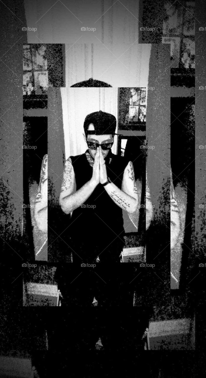 Young man/prayer stance/black and white /baseball cap/tattoos/Style/ Sunglasses/Looking down/Prayer hands Triple mirror image Gangster style/G.