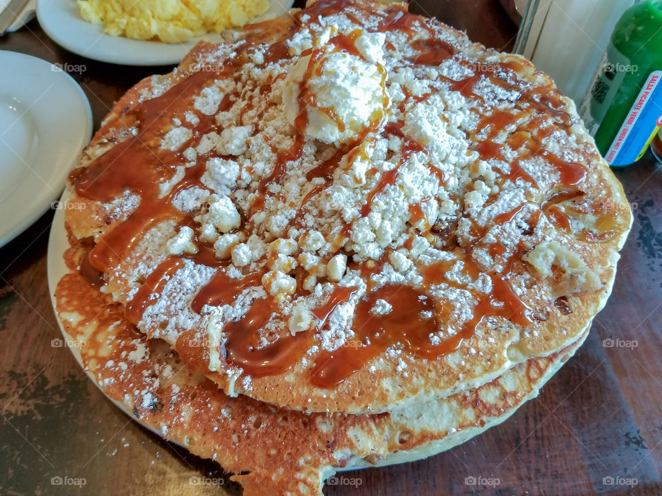 Delicious huge pancakes with powered sugar crumbs and caramel in Vancouver, Canada.