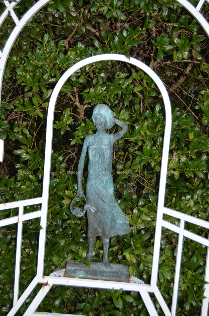 brass girl in garden