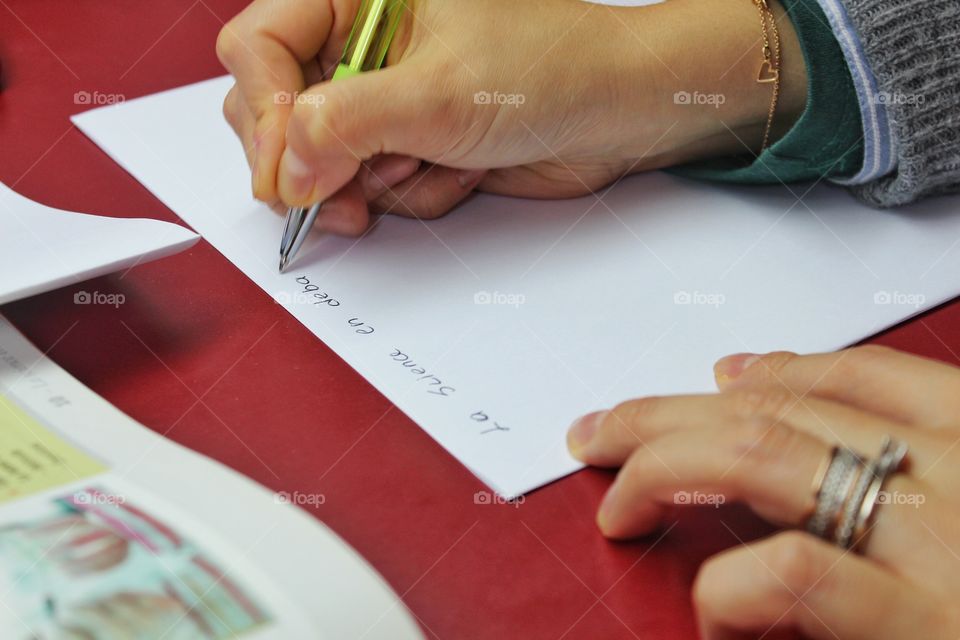 A woman writing in French.