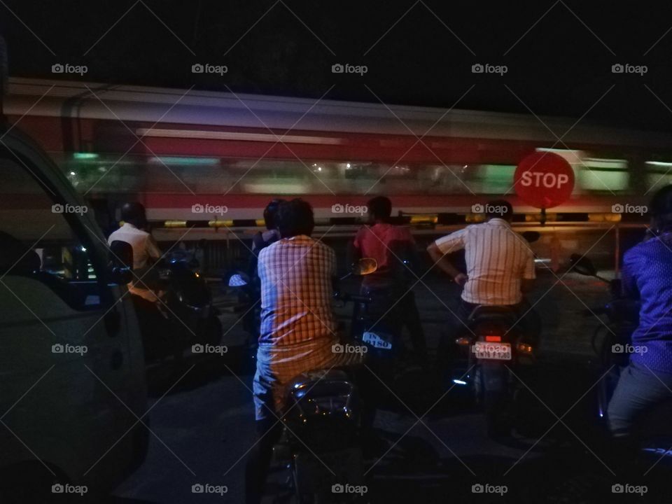 at night time travelers after train cross the road way capture instantly