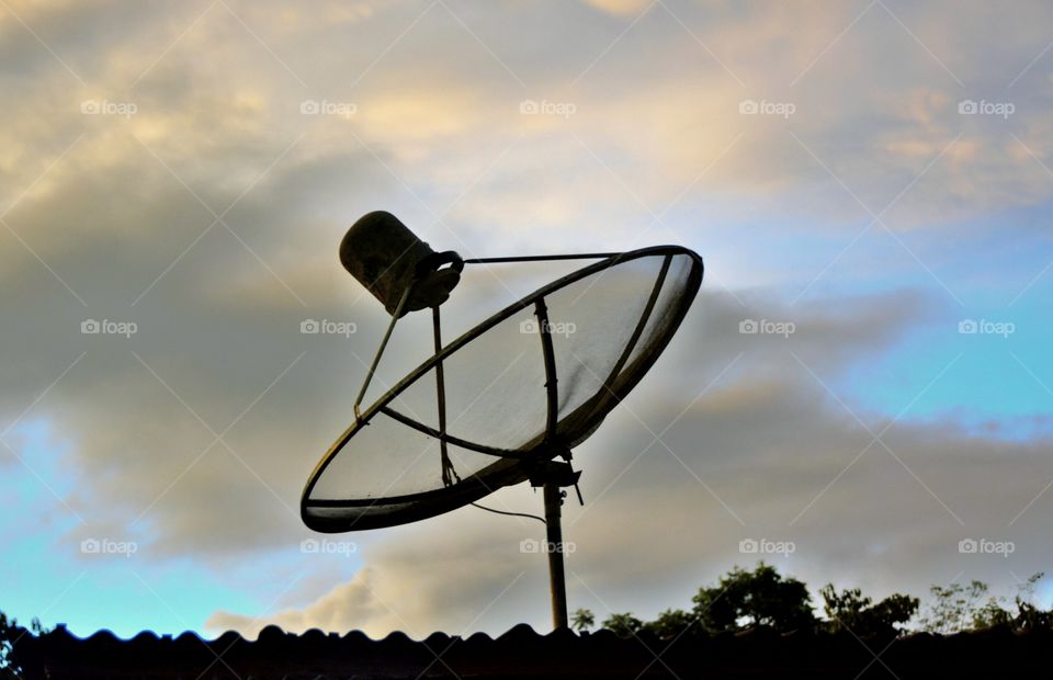 Satellite dish in sunset background