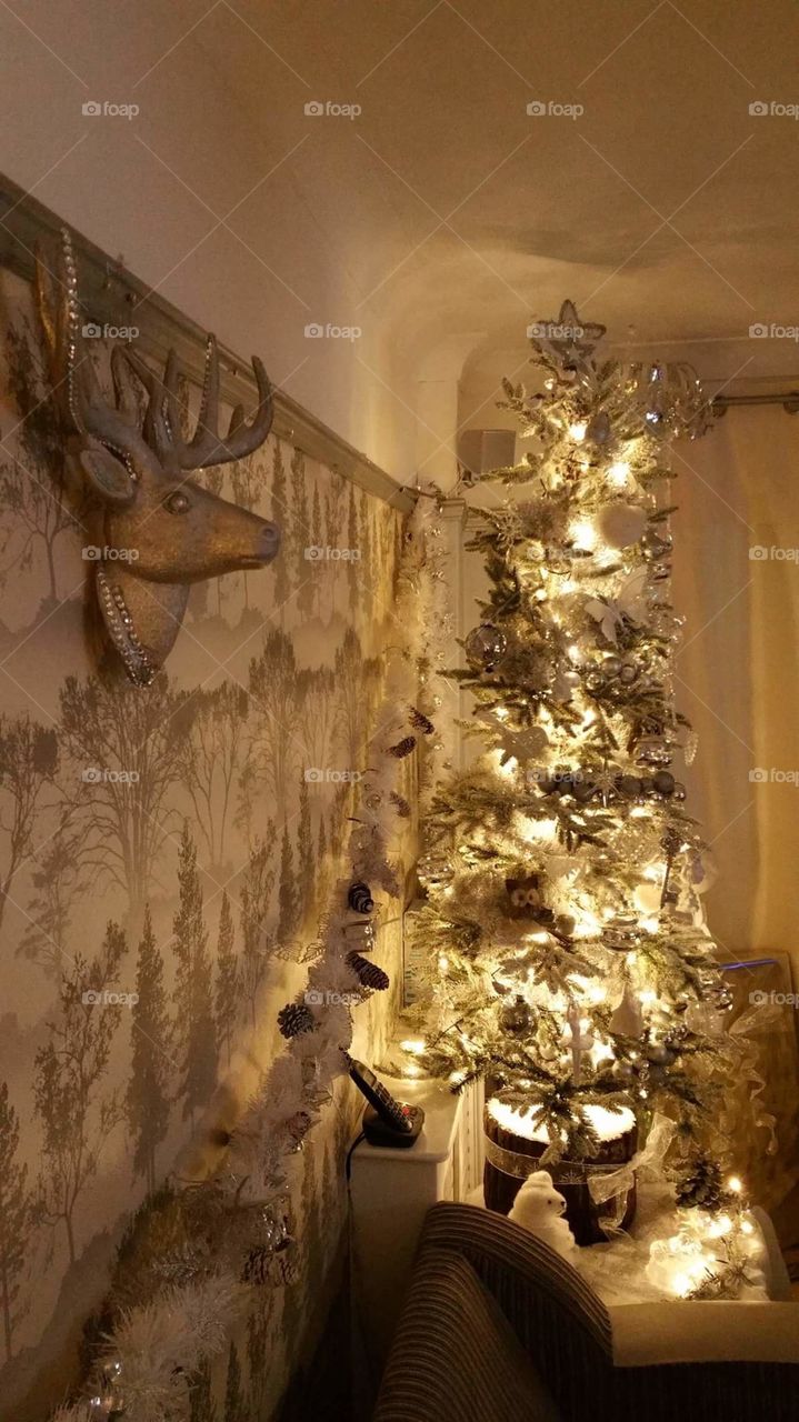 white and sliver frozen forest themed Christmas decorations. reindeer & Christmas tree.