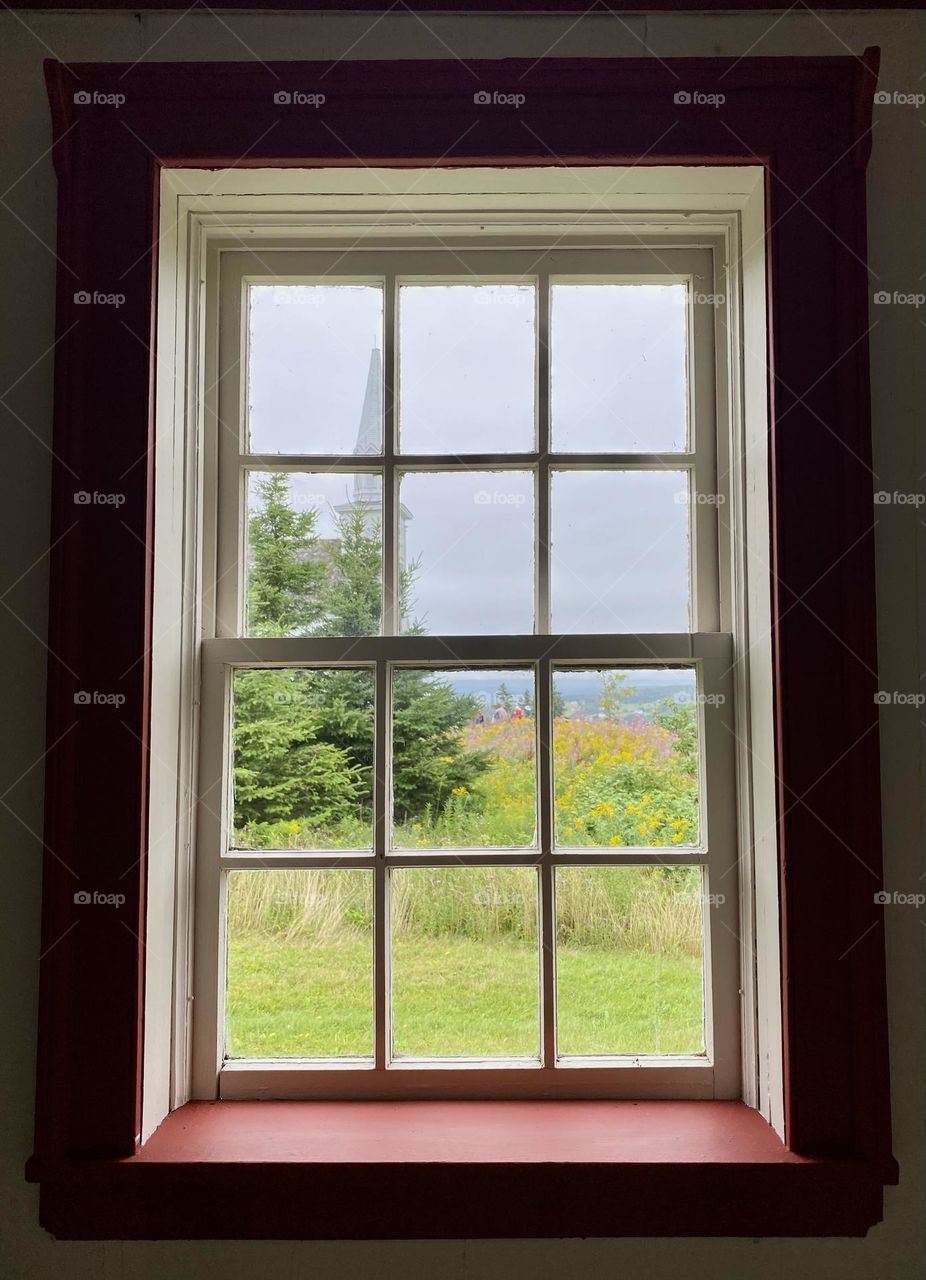 Looking out through a window towards a church
