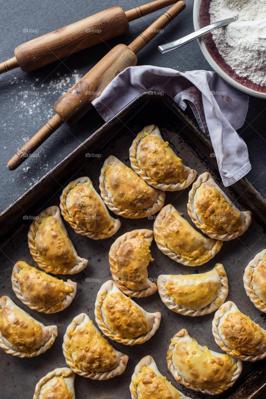 Pastry puffs filled with meat filling in the making.