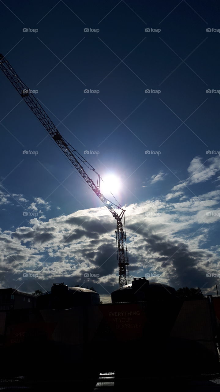 Sun Peeking Behind Red Crane