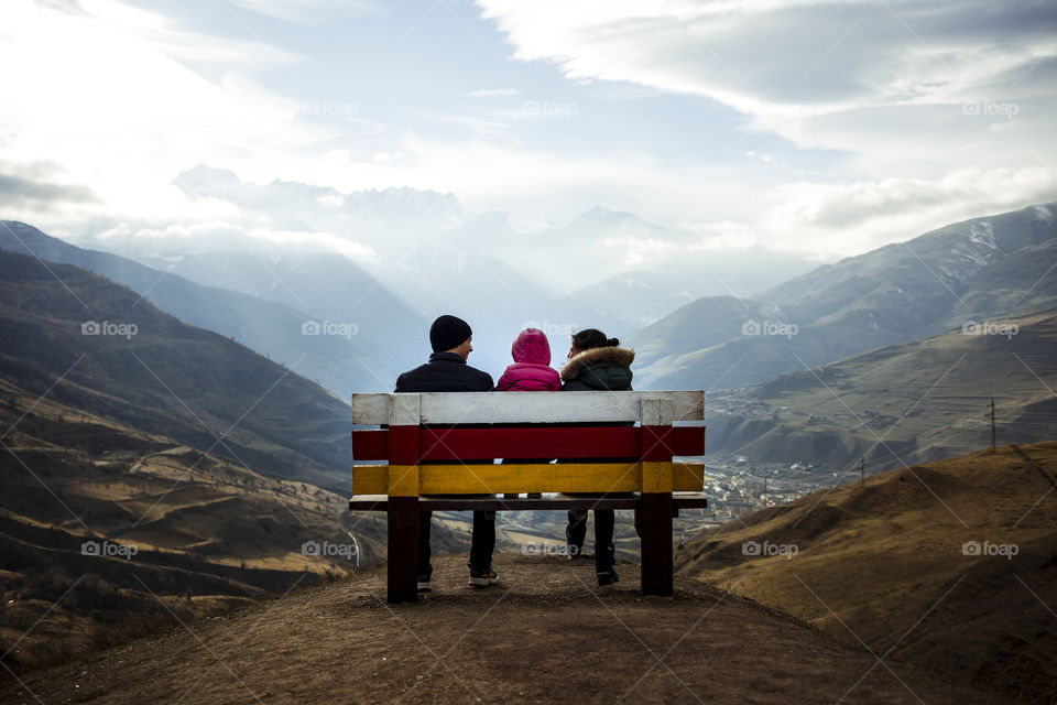 Back view of young family against mountain
