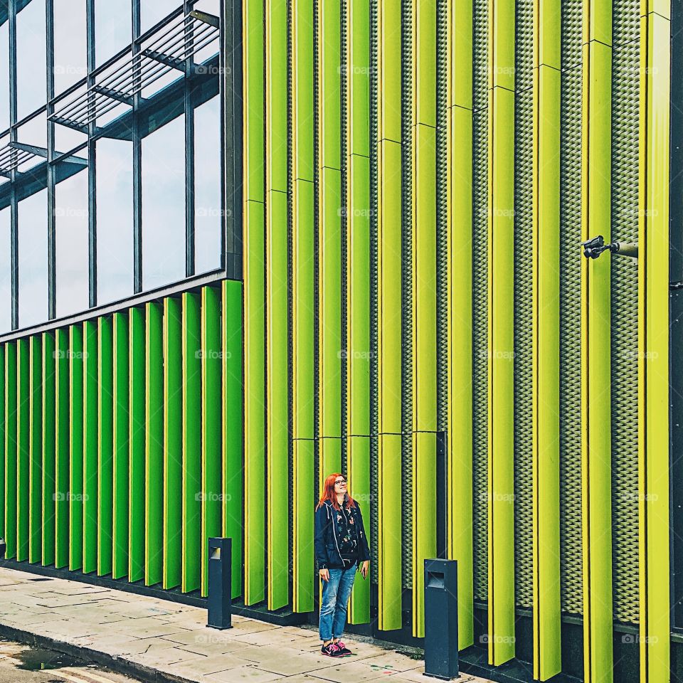 Woman standing beside building