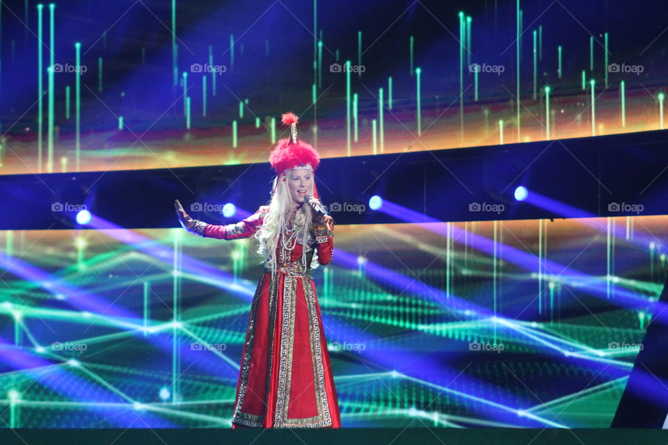 Blond singer with chinese costume at huge tv stage 