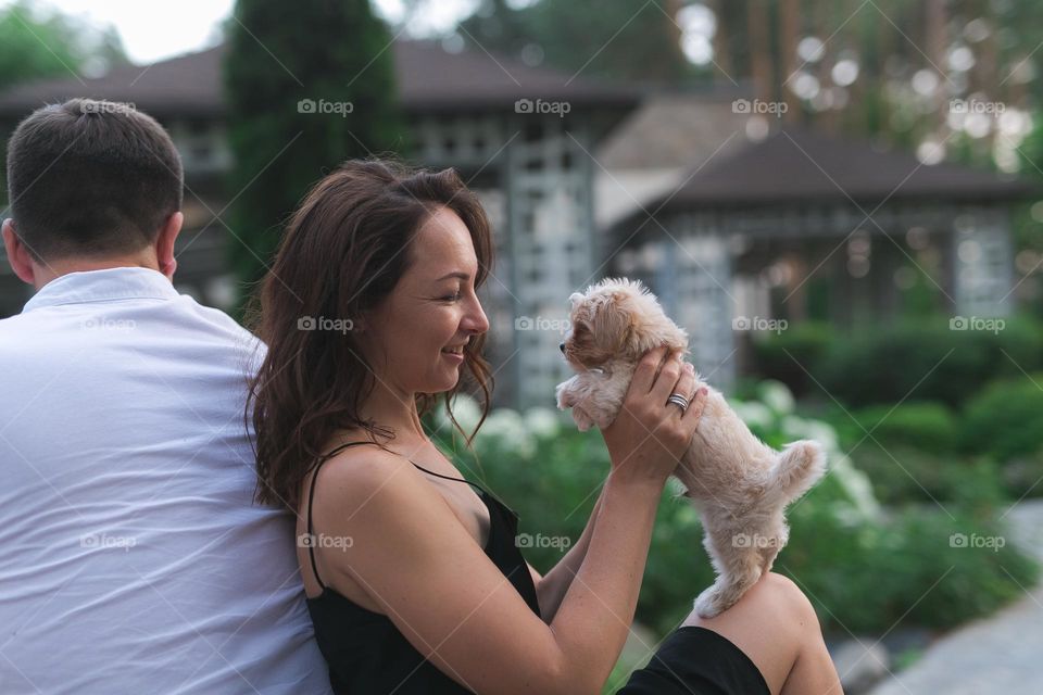 walking the dog down the street, the owner walks the weakling, teaches her, cleans up after her, educates, plays with his pet. people and dogs are best friends