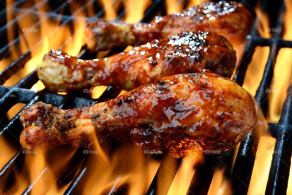 Chicken on a flaming barbecue grill