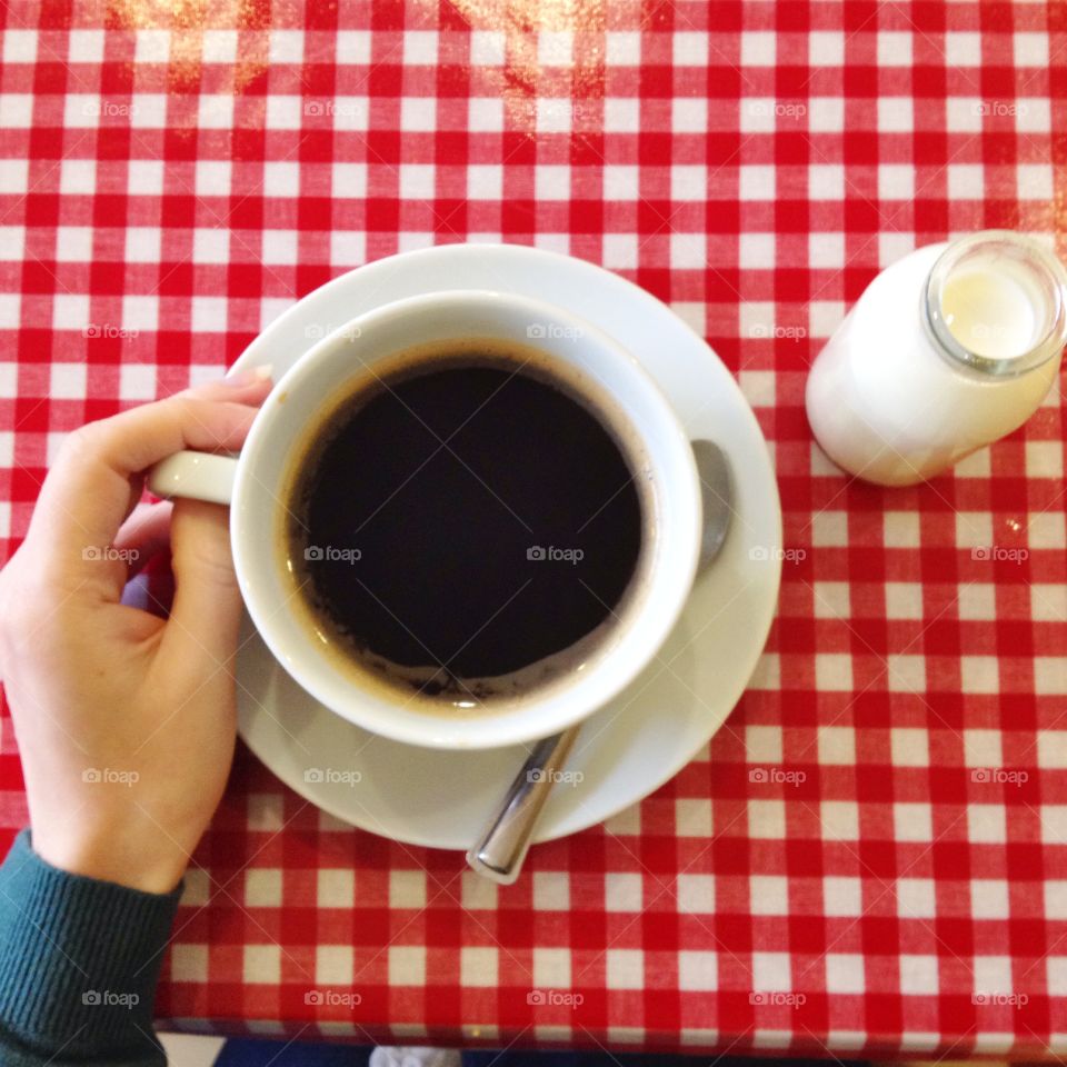 Morning coffee. Hand holding coffee cup