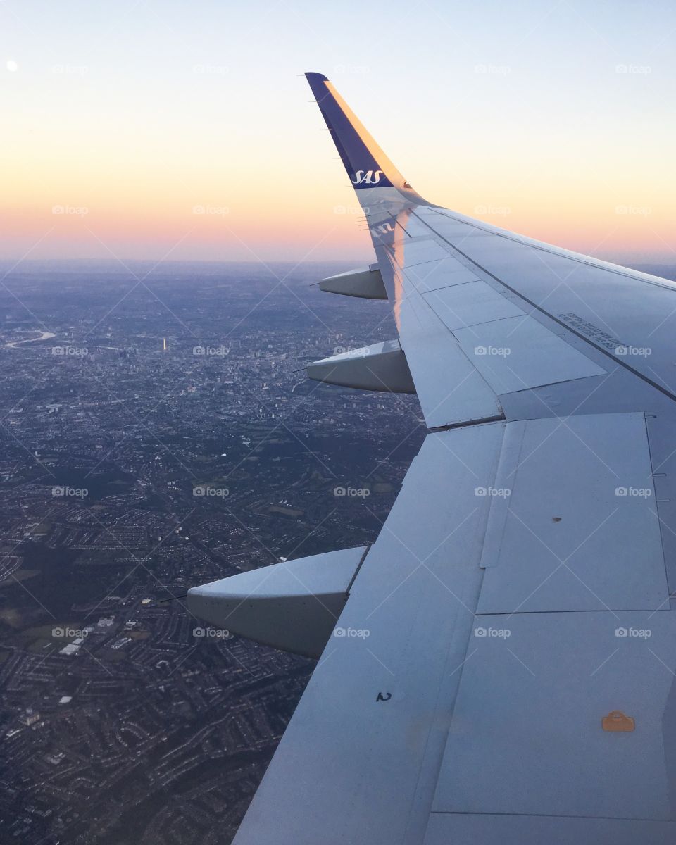 The view of a city from the window seat on a plane 