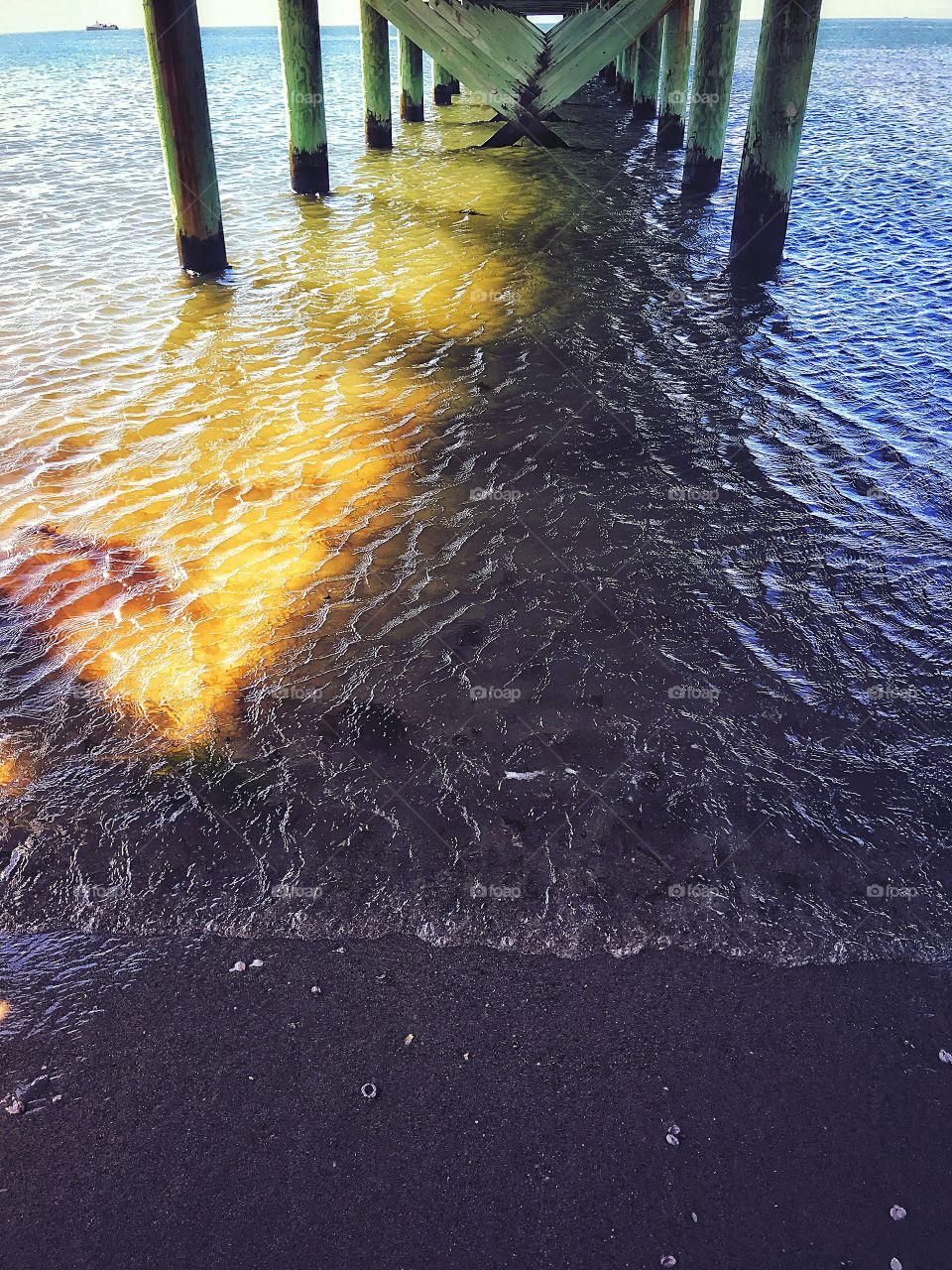 Sunlight beneath the pier