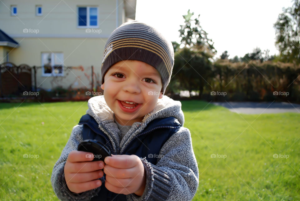 Cute boy standing in the garden against building