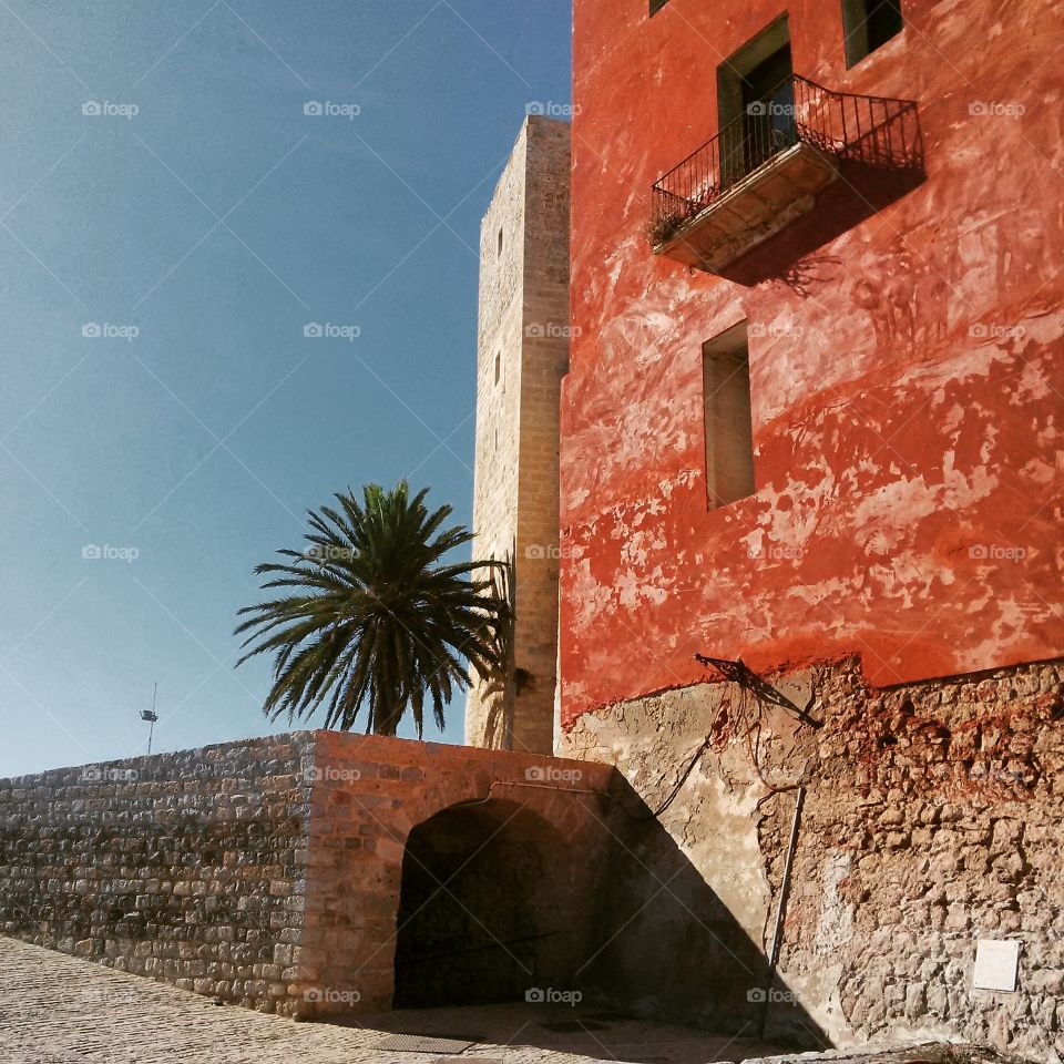 Contrasting hues on these old buildings at the highest point of the city of Ibiza.