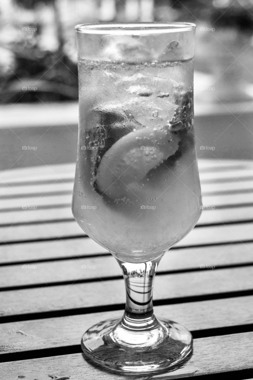 A glass with alcohol cocktail on the wooden table