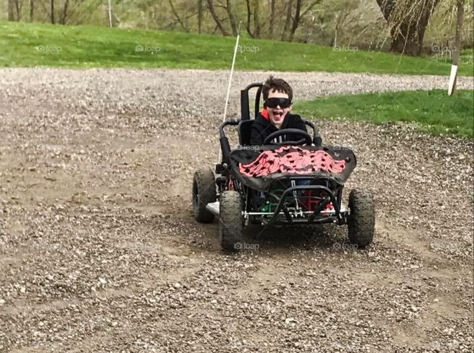 Young Boy Riding A Go Kart 