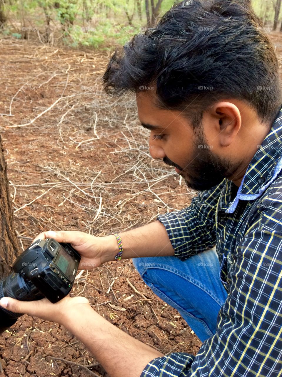 person operating his DSLR camera