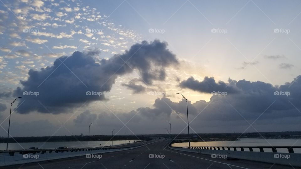 Driving on the Fred Hartman Bridge to church with the sunrise ahead.