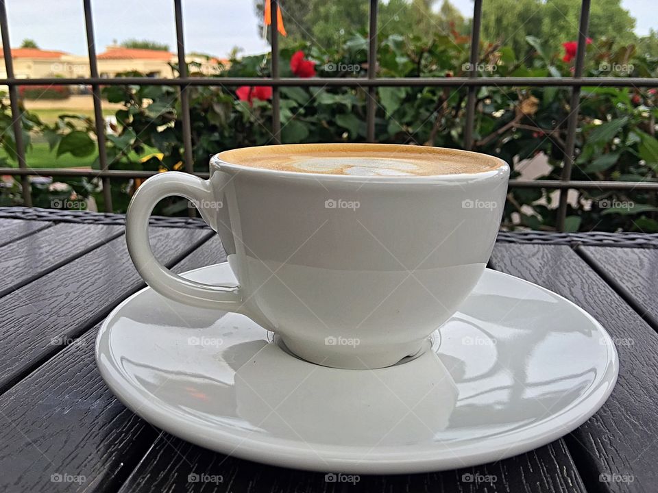 Cup of cappuccino on veranda.